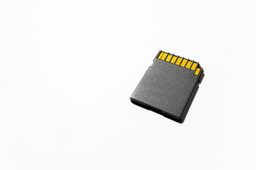 black memory flash card  for digital data with in the white background, selective focus. memory card with copy space for text