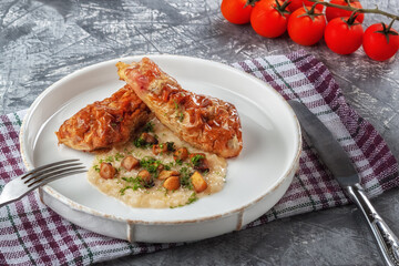 Chicken drumstick ballotin with onion sauce and mushrooms. Stuffed chicken legs