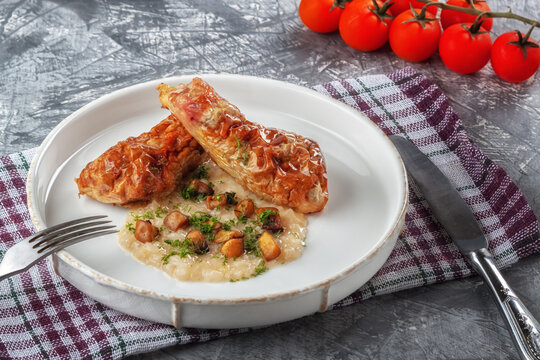Chicken drumstick ballotin with onion sauce and mushrooms. Stuffed chicken legs