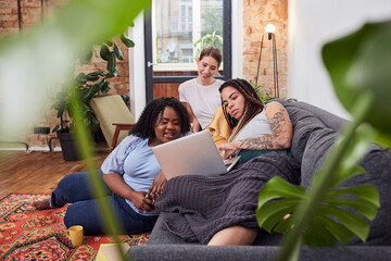 Fototapeta premium Relaxed young women enjoying a film at home
