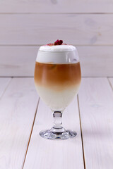 latte with rose on the wooden background