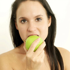 Woman biting on a green apple