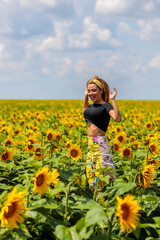 Fototapeta premium Pretty young woman on a sunflowers field