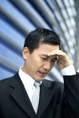 Businessman with hand on head