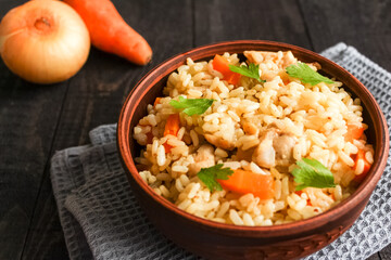 Rice With Meat, Carrot And Onion on wooden background