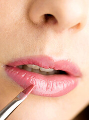 Naklejka premium Applying lip colour