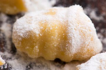 Uncooked homemade potato gnocchi with fork
