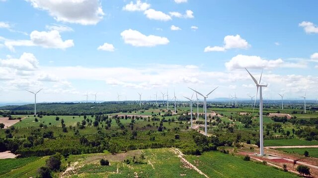 Aerial of Windmills for electric power production with white cloud and blue sky at Huai Bong, Dan Khun Thot district, Nakhon Ratchasima THAILAND. renewable energy and save  environmental, tilt up