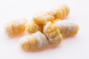 A pile of gnocchi on a white background