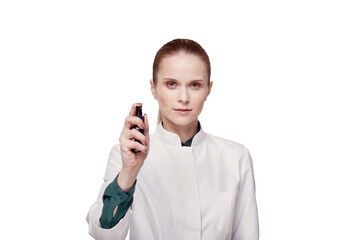A woman doctor in a white coat uses an antiseptic, an antiseptic in a spray.
