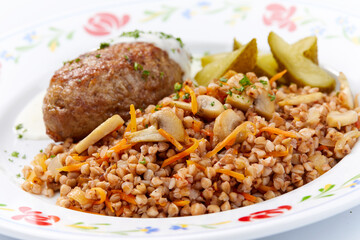 buckwheat with cutlet on white