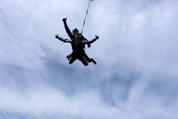 Fototapeta na wymiar Skydiving. Tandem jump. Two guys are flying in the sky.