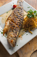 Branzino, whole grilled sea bream. Classic ethnic regional Greek  seafood favorite. Whole fish, grilled with skin in, served with lemon potatoes lemons Italian parsley and capers.