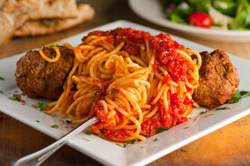 Pasta with meatballs, marinara sauce, Parmesan cheese and fresh Italian parsley. Classic American or Italian restaurant favorite. Homemade pasta with sauces, meats and cheeses.