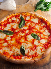 Pizza. Traditional New York City style margarita pizza pie with a thin homemade crispy crust, fresh tomato garlic marinara sauce topped with buffalo mozzarella cheese and fresh basil leaves.