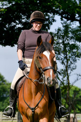 young woman riding horse
