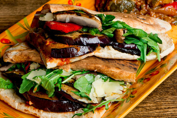 Sandwiches. Roasted and grilled Vegetables served on toasted focaccia bread. Deli style sandwiches with roasted red peppers, squash, basil and pesto spread. Classic American lunch favorite.