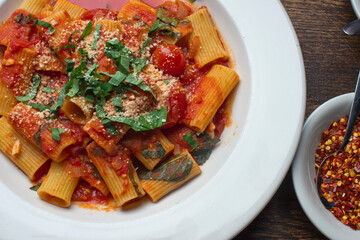 Rigatoni Pasta with meatballs, marinara sauce, Parmesan cheese and fresh Italian parsley. Classic American or Italian restaurant favorite. Homemade pasta with sauces, meats and cheeses.