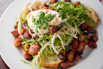 Garden salad. Classic American salad with iceberg lettuce, blue cheese dressing, red onions, bacon lardons, Parmesan cheese, olive oil, lemon juice, salt and pepper. A Fine dining restaurant classic.
