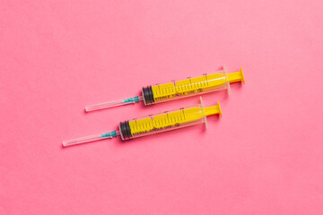 Top view of medical syringes on colorful background. Health care concept with copy space