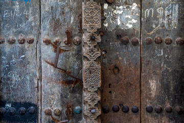 Old Swahili door in Zanzibar with metal knobs and hand carvings