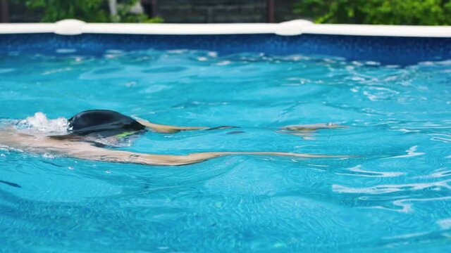  professional swimmer man practicing breaststroke in home pool slow motion shot 