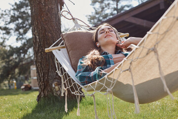 Happy lady with eyes closed resting in the garden