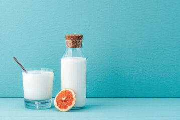 space milk in glass with orange fruit on vintage background colour