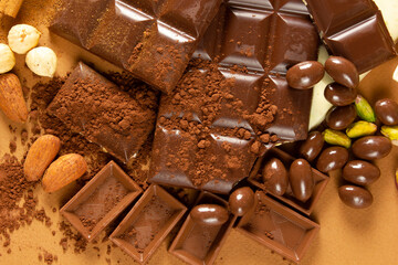 White and milk chocolates. Almond, pistachio, hazelnut.. background, texture..