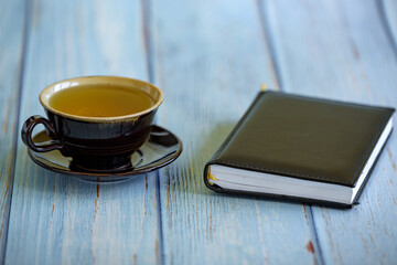 a cup of tea and a notebook