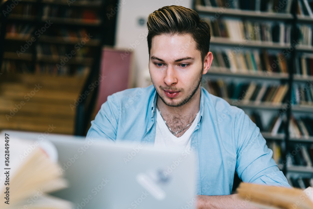 Poster young millennial male sitting at laptop computer watching education webinar for get knowledge from e