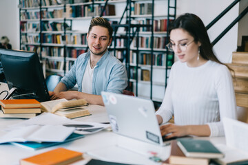 Smart student enthusiastically looking into the work of girlfriend