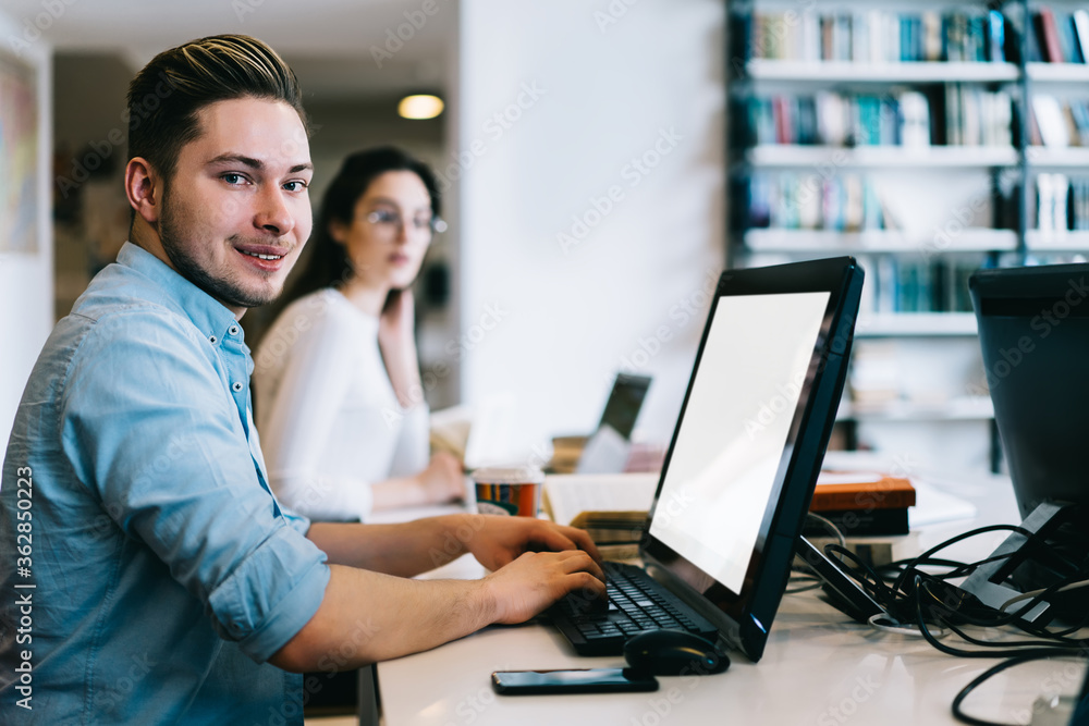 Poster portrait of skilled professional it developer keyboarding on computer with blank screen in office, s
