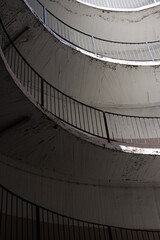 old and dirty car parking area with spiral stairs