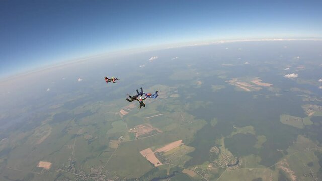 Skydiving. A group of skydivers is training in the sky.