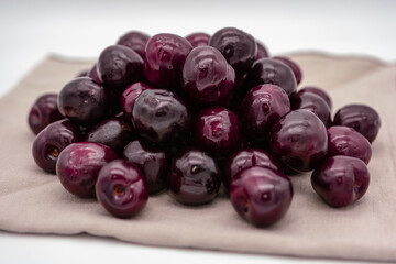  A group of ripe cherries on the plate.