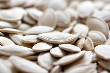 Fresh pumpkin seeds background. Close-up.