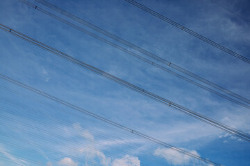 High-voltage electric line against blue sky
