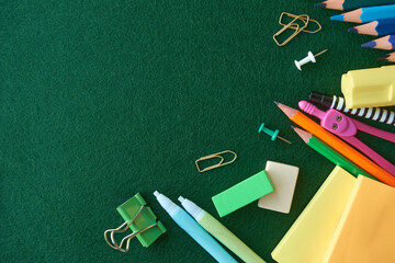 Stationery set on green background. School supplies top view for advertising and promotional items. Back to school concept