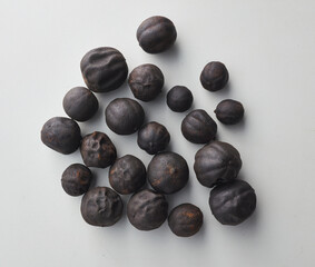 Top view shot of dried lime on white background.
loomi, limoo amani, black lime, persian lime