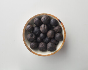 Top view shot of dried lime on white background.
loomi, limoo amani, black lime, persian lime
