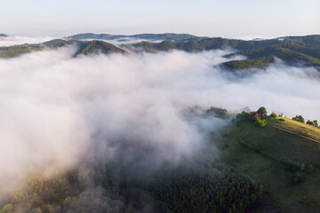 Aerial landscape of beautiful green hills in Transylvania, at the feet of the Carpathians