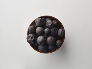 Top view shot of dried lime on white background.
loomi, limoo amani, black lime, persian lime