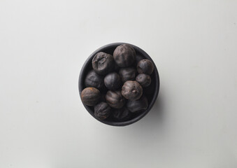 Top view shot of dried lime on white background.
loomi, limoo amani, black lime, persian lime