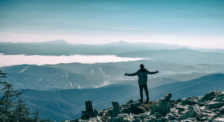 Happy hiker winning reaching life goal, success, freedom and happiness, achievement in mountains....