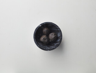 Top view shot of dried lime on white background.
loomi, limoo amani, black lime, persian lime