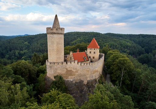 Aerial view of a medieval castle, Kokorin. Fortified palace with a tower and a wall standing on a hill covered by trees.Tourist spot. Castles in the Central Bohemian Region, Czech republic.