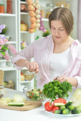 Portrait of teen girl preparing fresh salad