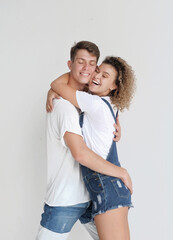 Happy young couple posing on white background