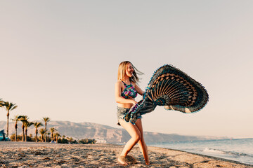 Woman running and holding scarf on wave relax and happy on beach